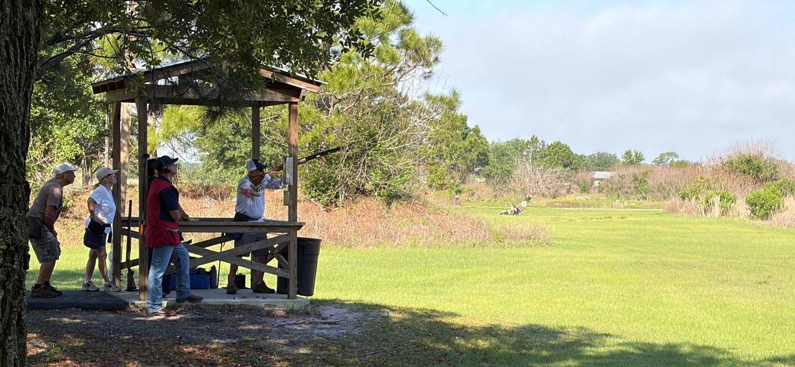 Shooters at a wooden station on the sporting clays course